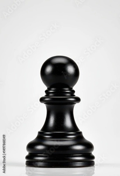 Fototapeta Elegant black chess pawn on a minimalist backdrop, perfect for strategy and gaming themes.