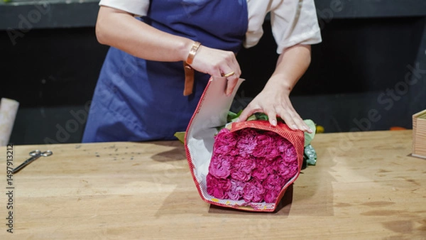 Fototapeta Florist unpacking a package of roses. Small business.  Close-Up.  Soft focus.