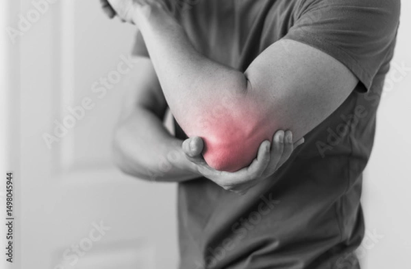 Fototapeta Man with elbow injury showing red highlights pain relief concept concept muscle pain due to lateral epicondylitis or tennis elbow injury, Health care concept 