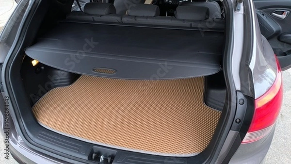 Obraz Car trunk interior with carpet and storage space