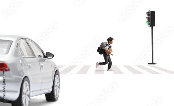 Fototapeta Schoolboy running on a street and car waiting at a zebra crossing
