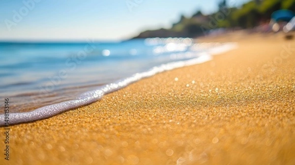 Fototapeta Soft Ocean Waves Gently Caressing Golden Sand on Sunny Beach