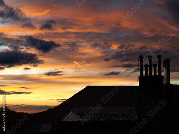 Fototapeta Vibrant orange storm clouds over evening sky