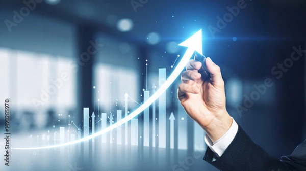 Fototapeta Realistic image of a hand drawing an upward arrow on a transparent screen, with bright light effects, financial charts overlay, and symbols of profit and business growth.