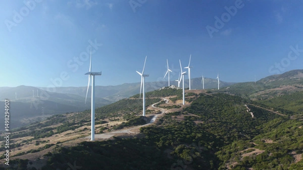 Obraz Drone aerial view of wind turbines create electricity close-up. Clean eco renewable green energy concept. Sustainable development. Windmill blades rotate produce power. Alternative eco-friendly farm.