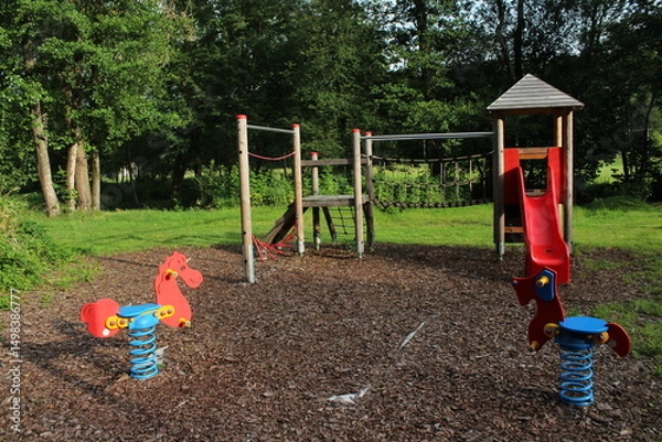 Obraz A children Colorful playground on yard in the park. the green grass 
