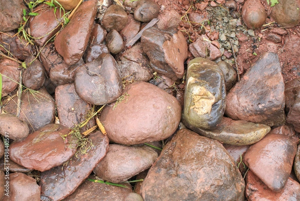 Fototapeta River rocks showcasing natures variety in texture and color. Abstract background diverse geological composition.
