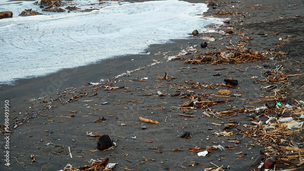 Obraz Garbage is scattered on the beach sand