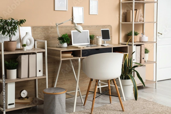 Fototapeta Modern stylish workplace with laptop and tablet in office