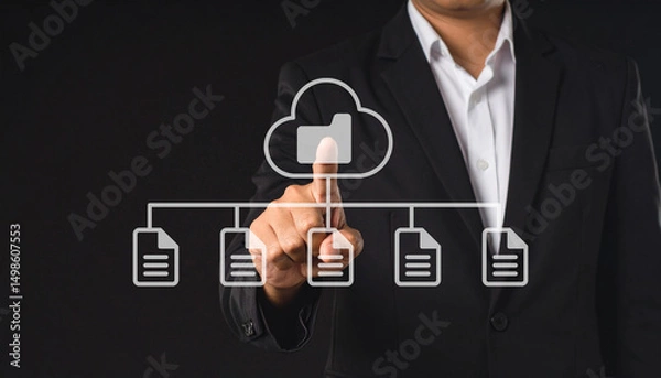 Obraz A businessman in a suit interacts with a virtual cloud storage interface, selecting a folder connected to multiple documents.