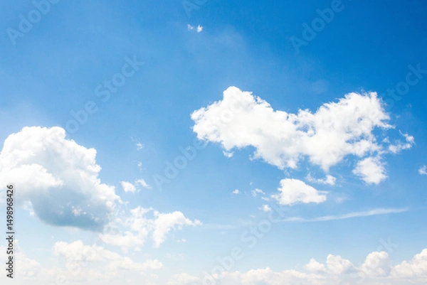 Fototapeta sky with fluffy clouds. azure peaceful softness.white cumulus cloudscape on a blue gradient of atmosphere. sunny summer weather. scenic nature background. meteorology backdrop. fresh air