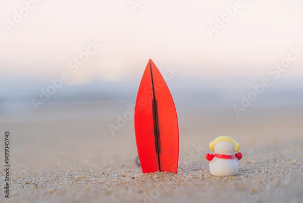 Fototapeta Sandy Christmas Snowman is watching the waves, standing on beautiful beach with a surf board - horizontal version in Patong Beach, Phuket, Thailand