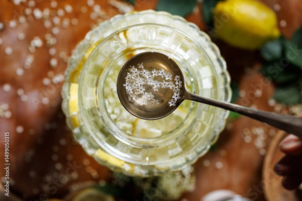 Obraz Close-up view of a ladle of elderflower syrup, top view