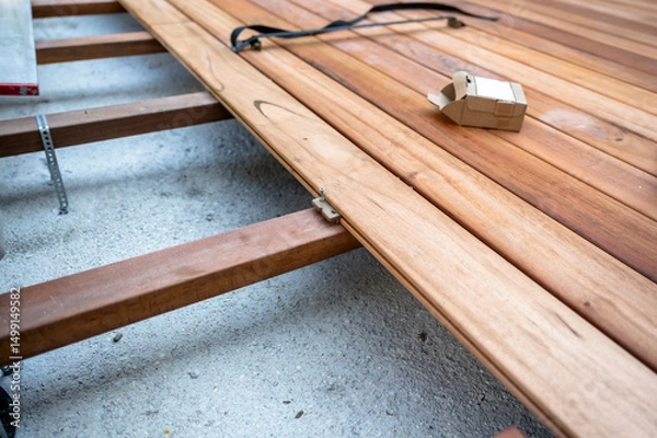 Obraz Wood deck construction with hidden fasteners during installation process