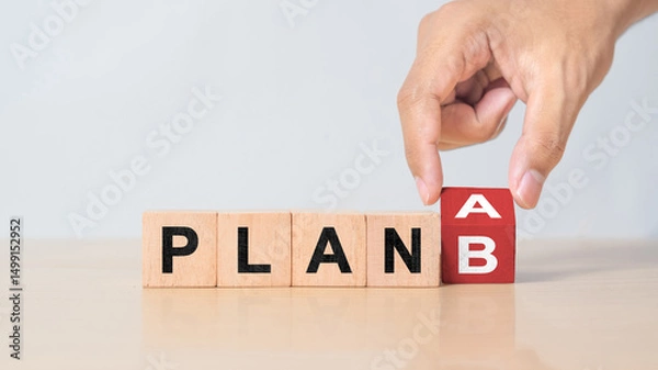 Obraz Businessman hand flipping wooden cube blocks with PLAN A change to PLAN B text on table background. strategy, analysis, marketing, project and Crisis concepts