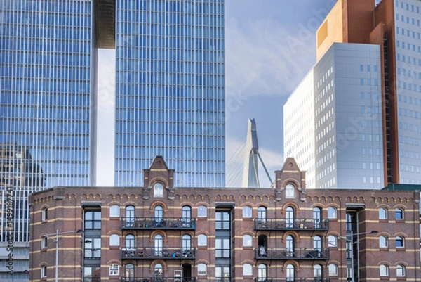 Fototapeta Cityscape of Rotterdam with large modern ancient apartment buildings and Erasmus bridge in background, Kop van Zuid in Rotterdam port city in South-Holland the west of the Netherlands