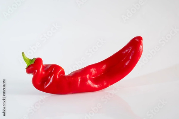 Fototapeta Organic red chili pepper isolated on a white background. Capsicum annuum, commonly called bell pepper or sweet pepper, from the Solanaceae family.