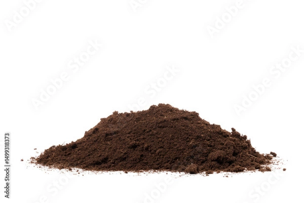 Fototapeta A close up shot depicting a pile of dark brown soil against a stark black background in a studio setup