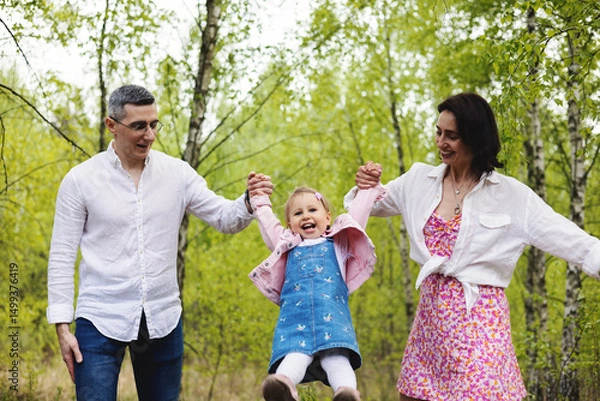 Fototapeta Happy family playing in the park