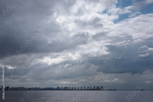 Fototapeta Landscape of the Gulf of Finland in St. Petersburg. Dramatic clouds over the water surface of the Baltic Sea.