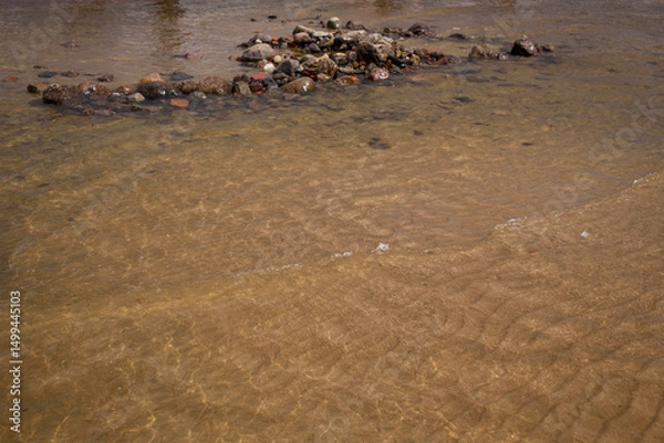 Fototapeta Natural natural background. Transparent surface of the sea in shallow water.