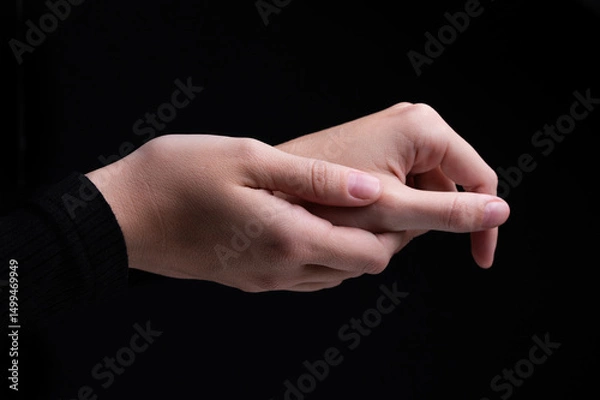 Obraz Female hands on a black background. Concept of tenderness and self-care.