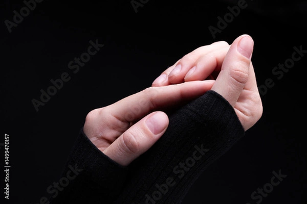 Obraz Female hands on a black background. Concept of tenderness and self-care.