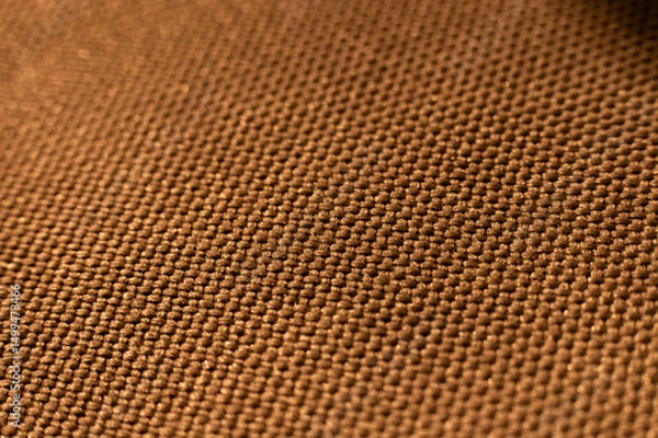 Obraz Close-up texture of textile surface. Extreme macro close-up of synthetic fabric surface. Gold background in shallow depth of field
