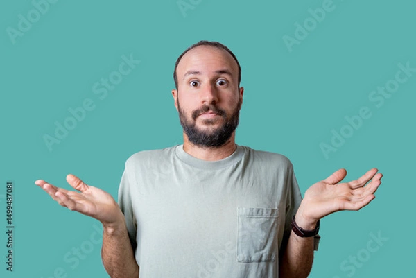 Fototapeta portrait of young man confused an uncertain, shrugging with open hands. Bewildered and clueless person