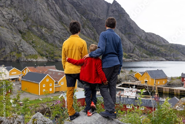 Obraz Typical Rourbuer fishing cabins in Lofoten Nusfjord village on a rainy day, summertime. Traditional norwegian red house