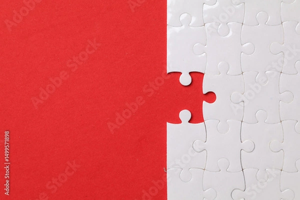 Obraz White Jigsaw Puzzle on red Background. symbolizing completion Team success partnership or teamwork	