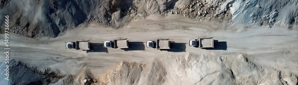 Fototapeta Drone view of autonomous trucks moving in perfect formation across quarry
