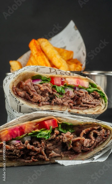 Fototapeta Delicious Beef Wrap Shawarma with Fresh Vegetables and French Fries,closeup