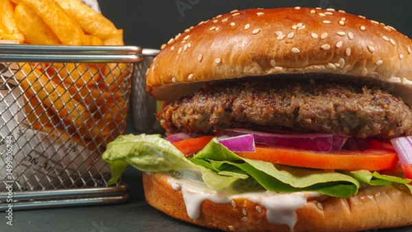 Fototapeta Fresh beef burger with Crispy French fries closeup on black background