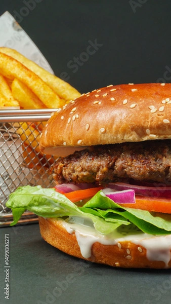 Fototapeta Fresh beef burger with Crispy French fries closeup on black background