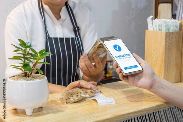 Fototapeta customer using smartphone for payment at cafe restaurant by mobile digital wallet. cashless society, QR code scanning and money transfer via mobile banking concept