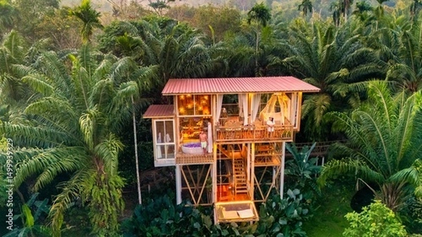Fototapeta Unique treehouse retreat nestled high in lush jungle rainforest for a serene escape