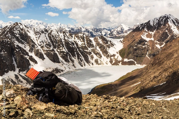 Obraz Backpack on the mountain pass with a view over the frozen lake Ala-Kul from mountain pass. Tien Shan. Kyrgyzstan