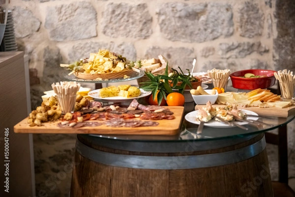 Fototapeta Traditional wooden board with assorted Italian cured meats and salami ready to serve