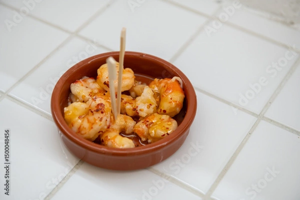 Fototapeta Assorted Italian appetizers on rustic wooden board with vibrant Mediterranean ingredients