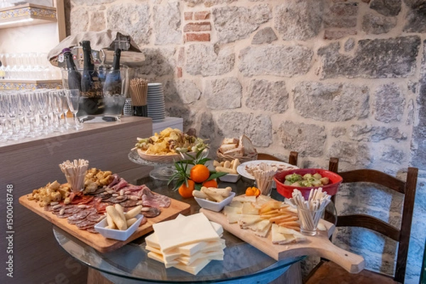 Fototapeta Traditional wooden board with assorted Italian cured meats and salami ready to serve