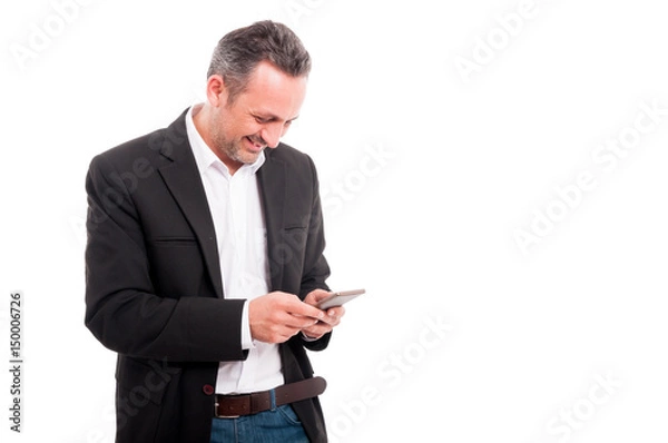 Fototapeta Happy young businessman reading text message on cellphone
