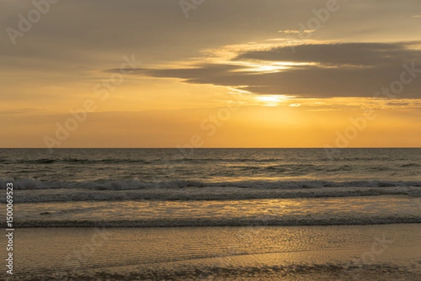Fototapeta Beautiful sunrise over the ocean with birds soaring through the morning sky. The soft glow of dawn bathes the water and horizon in gentle pastel colors, creating a peaceful and atmospheric coastal sce