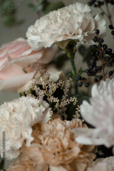 Obraz White carnation with black berries and soft pastel flowers. Elegant floral bouquet in natural light, perfect for background or design.
