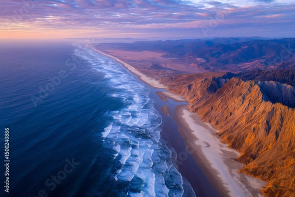 Obraz Aerial view of dramatic coastline with ocean waves and eroded cliffs during colorful sunset