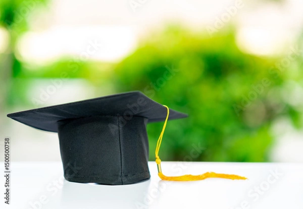 Fototapeta A graduation cap with a yellow tassel.