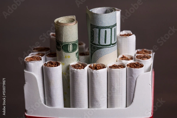 Obraz Cigarette concept inside a pack with money as in burning your money to buy drugs 