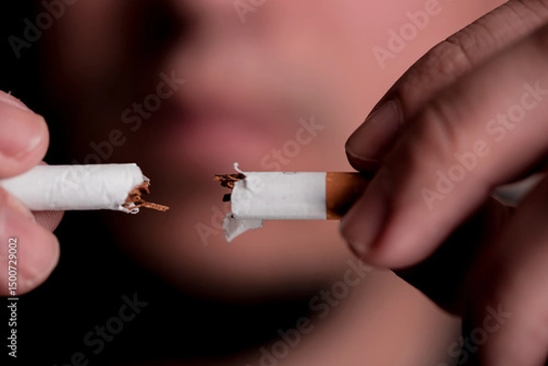 Obraz Concept image of a man cutting the habit of quitting smoking. Burning cigarette with smoke and concept of cigarettes 