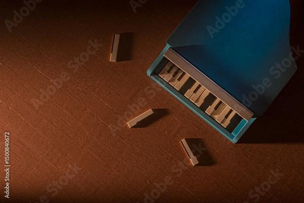 Obraz Blue toy piano with three broken keys on the floor. The piano is not in good condition and the wood pieces are scattered around it. Metaphor of hard childhood and kids troubles. 3d render