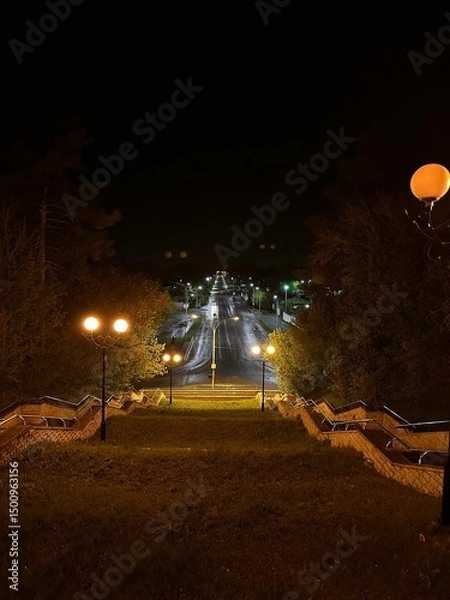 Fototapeta A street with a sidewalk and a staircase